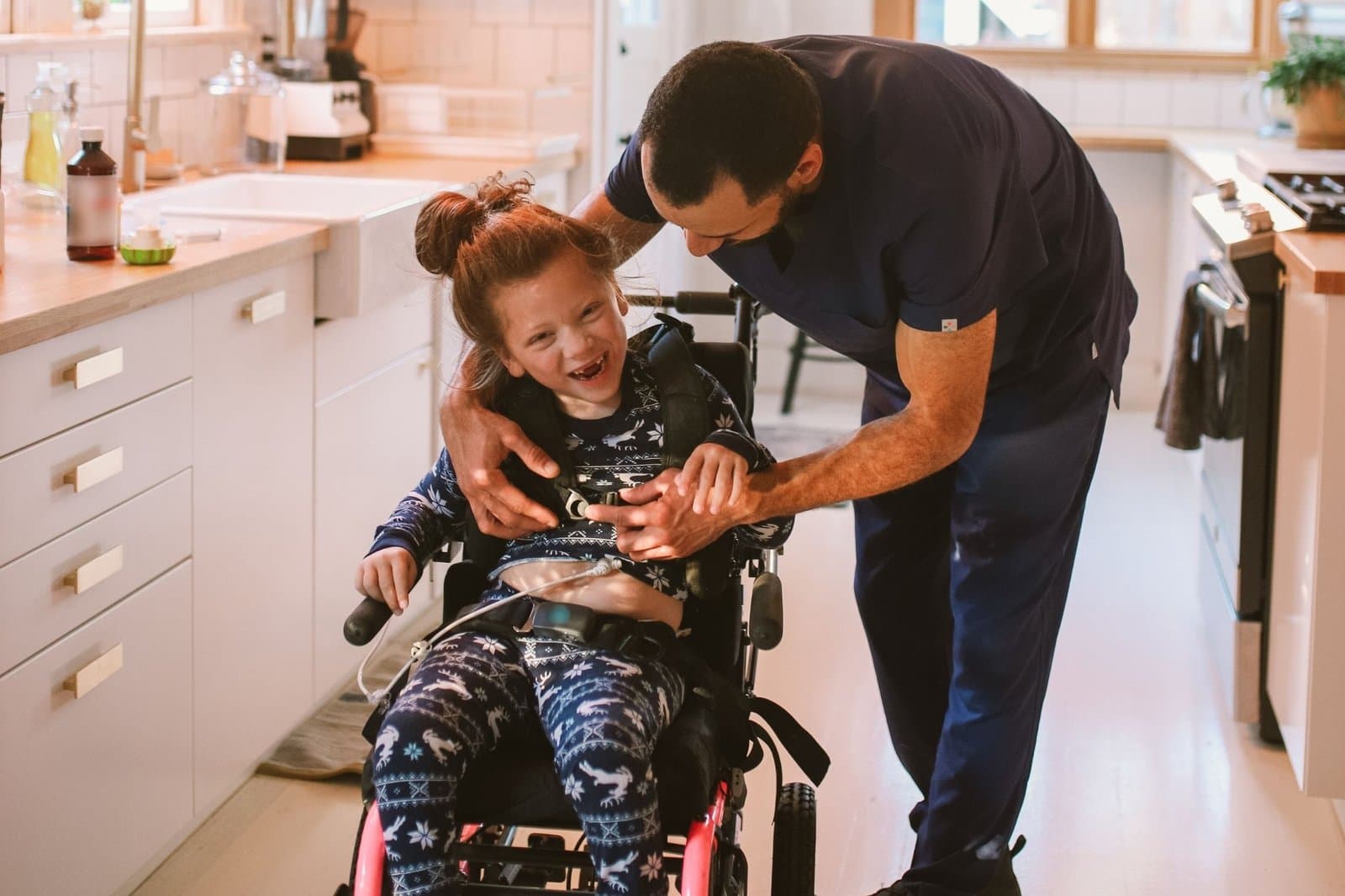 A Crescent Care support worker sharing a joyful moment with a young participant